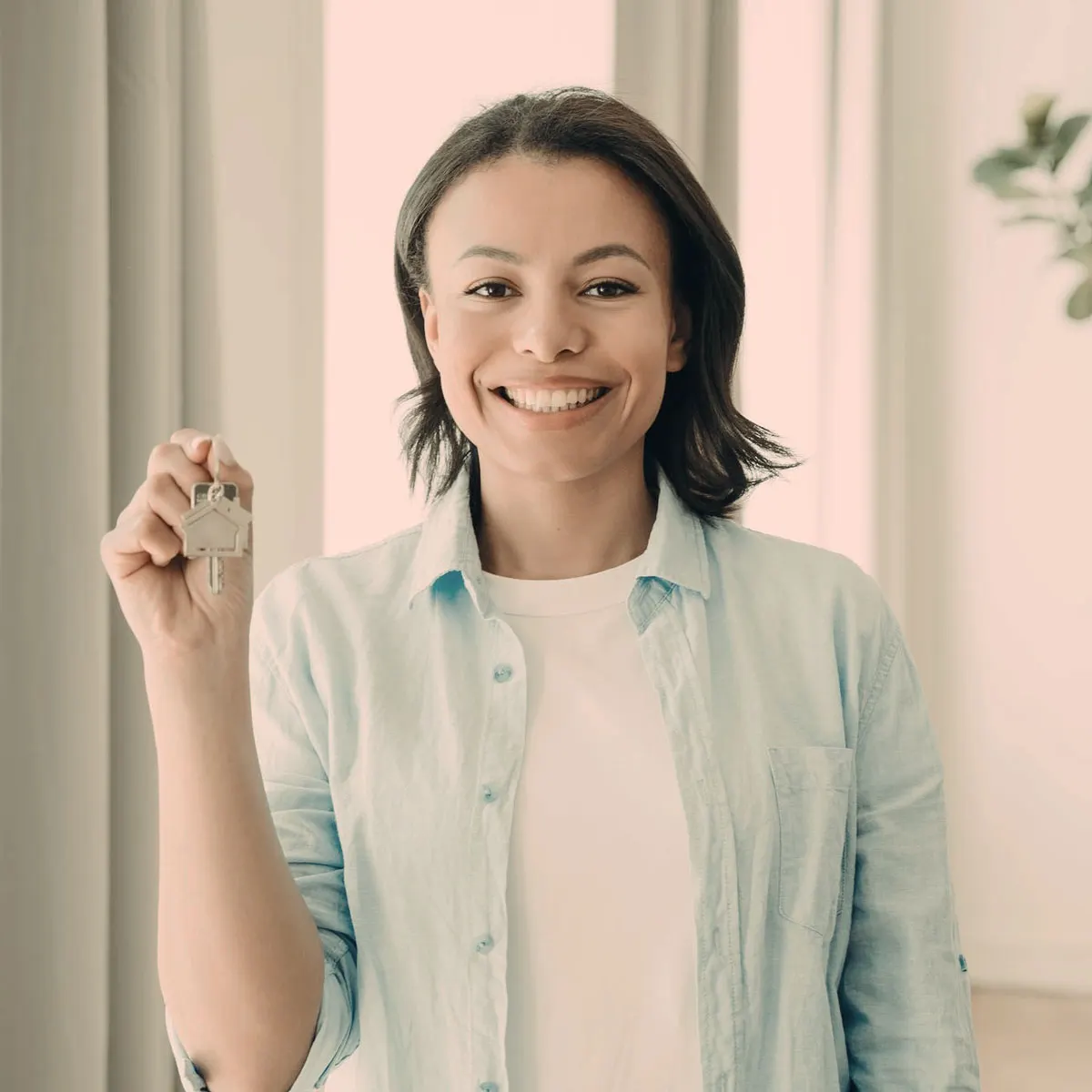 Smiling woman holding up a set of keys