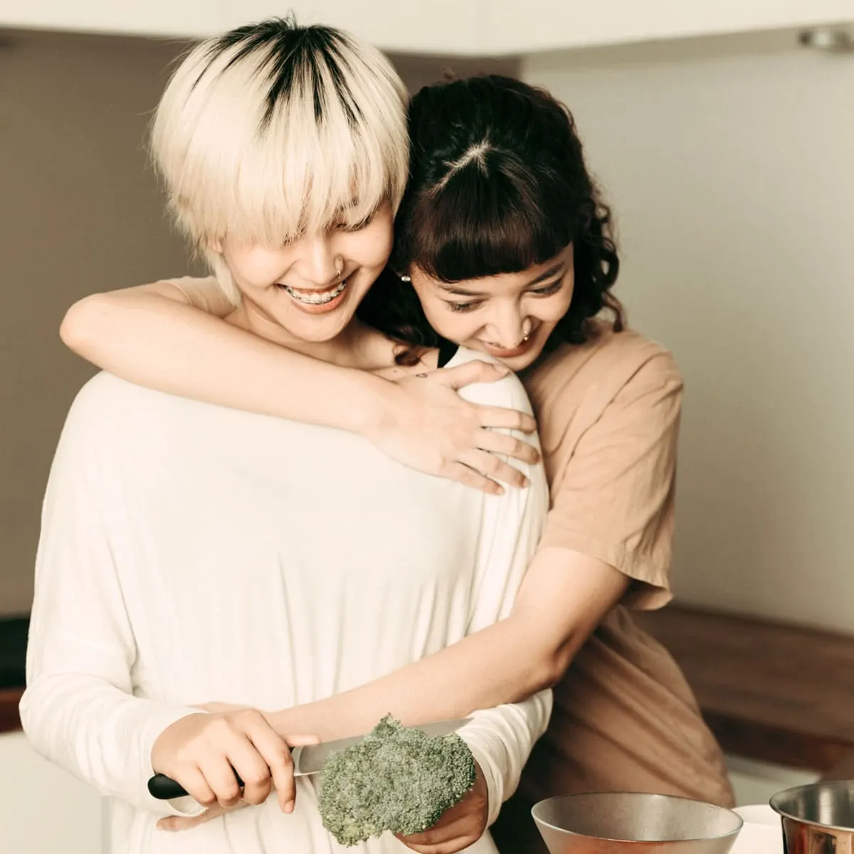 Two women hugging in their kitchen